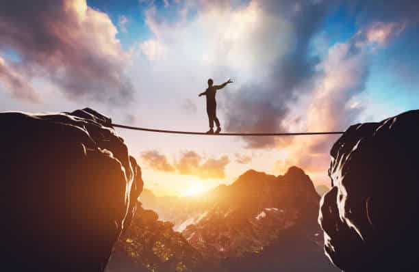 Man walking on rope between two high mountains at sunset. Concept of taking a risk, adventure, motivation. 3d illustration